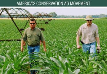 Producer Tommy Young, left, walks out of a Jackson County, Ark., corn field alongside Chris Henry, water management engineer at the University of Arkansas Rice Research and Extension Center.