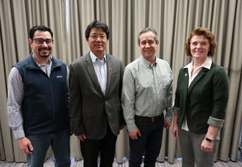 L to R: Edison Magalhaes, Jianqiang Zhang and Cesar Corzo with Lisa Tokach at the AASV Annual Meeting in Atlanta, Ga. 
