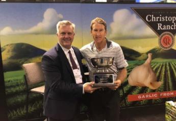 The Packer's Tom Karst (left) presents the 2019 Produce Marketer for All Seasons award to Bill Christopher of Christopher Ranch, who accepted the award on behalf of his father Don Christopher. 