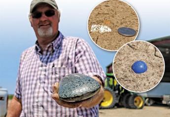 Mississippi producer Bernie Wright holds a hefty Native American celt  found jutting out of a field this past spring. To the right are pictures of a Civil War-era bullet and an old marble.