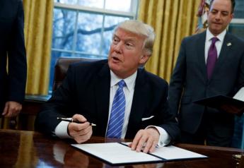 President Donald Trump signs an executive order to withdraw the U.S. from the 12-nation Trans-Pacific Partnership trade pact agreed to under the Obama administration, Monday, Jan. 23, 2017, in the Oval Office of the White House in Washington.