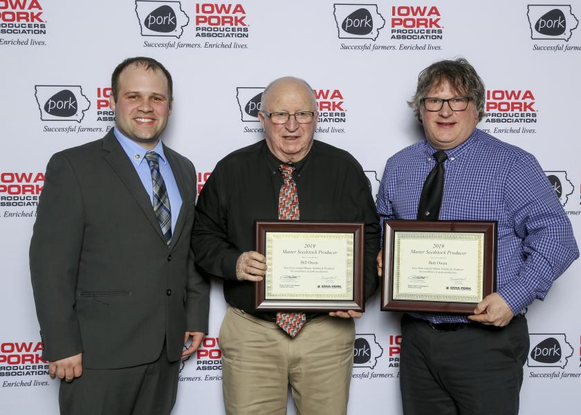  (l to r) Ben Schmaling, president of the Iowa Purebred Swine Council, presents the 2019 Master Seedstock Award to Bill Owens and Bob Owens.