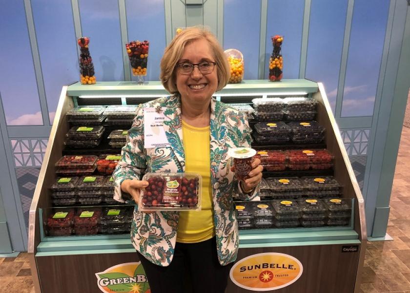 Janice Honigberg, president of Sun Belle,   Schiller Park, Ill. displays cranberries and pomegranate arils at the Produce Marketing Association's Fresh Summit expo.